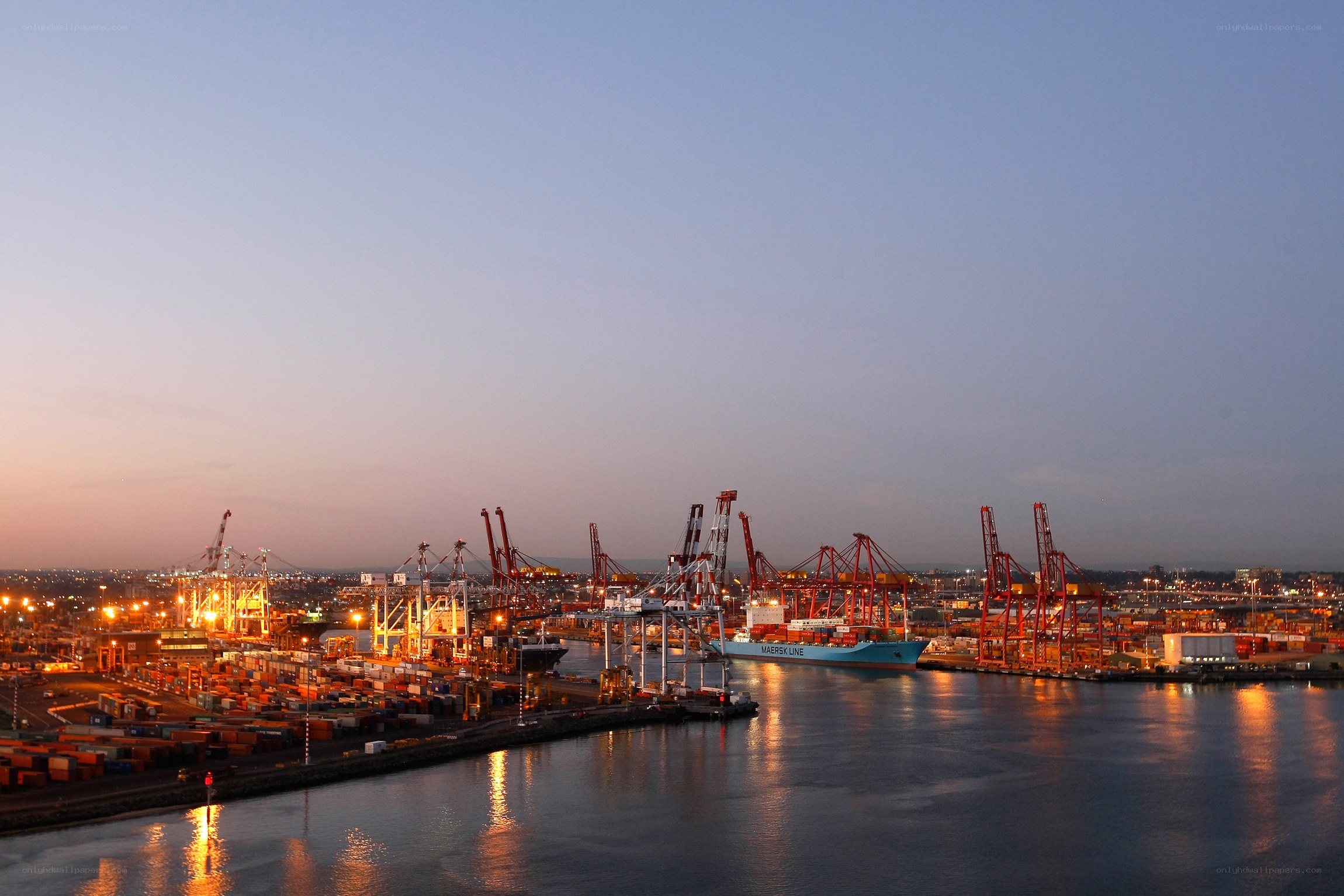 port at dusk with cranes
