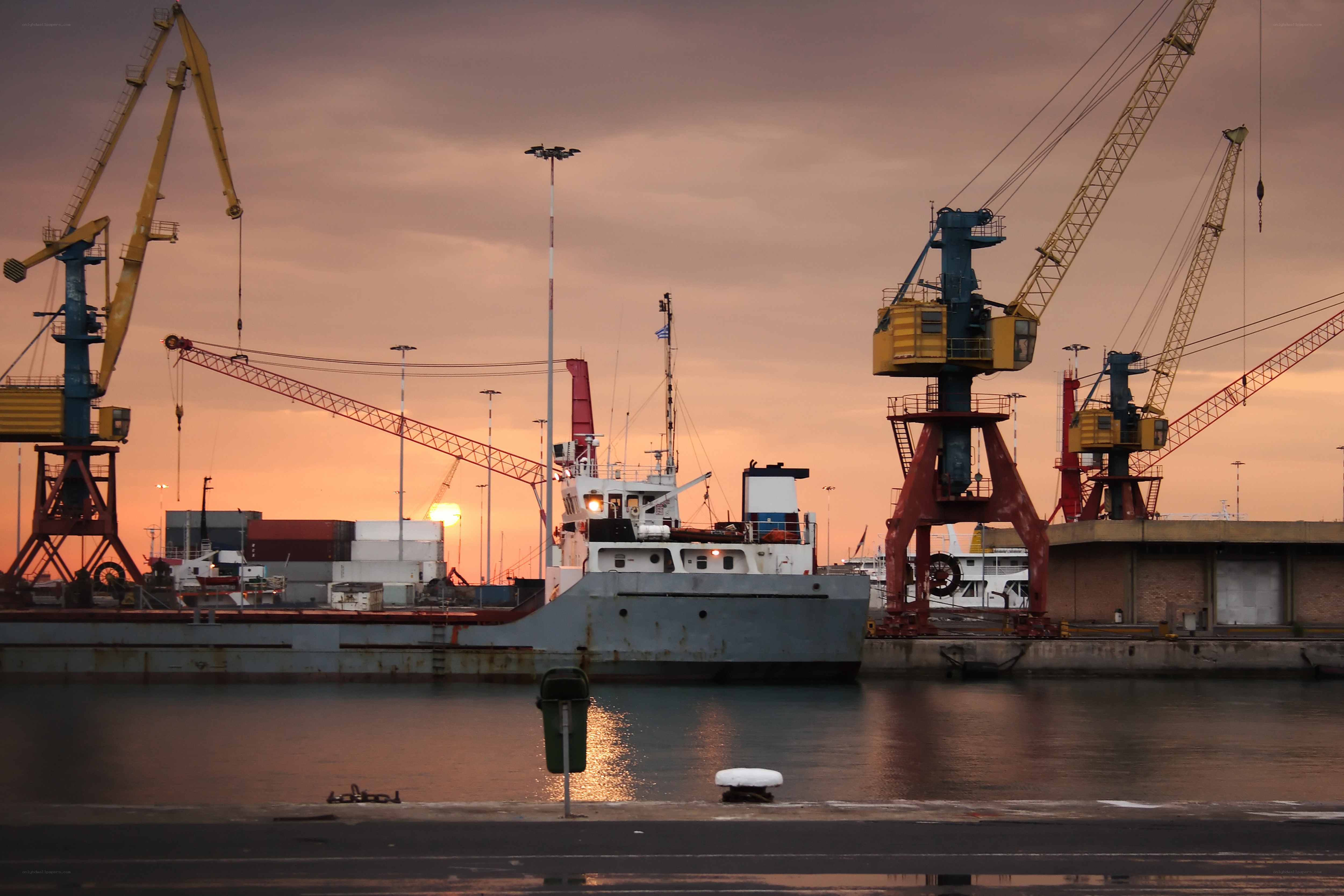 Port at sunset with cranes
