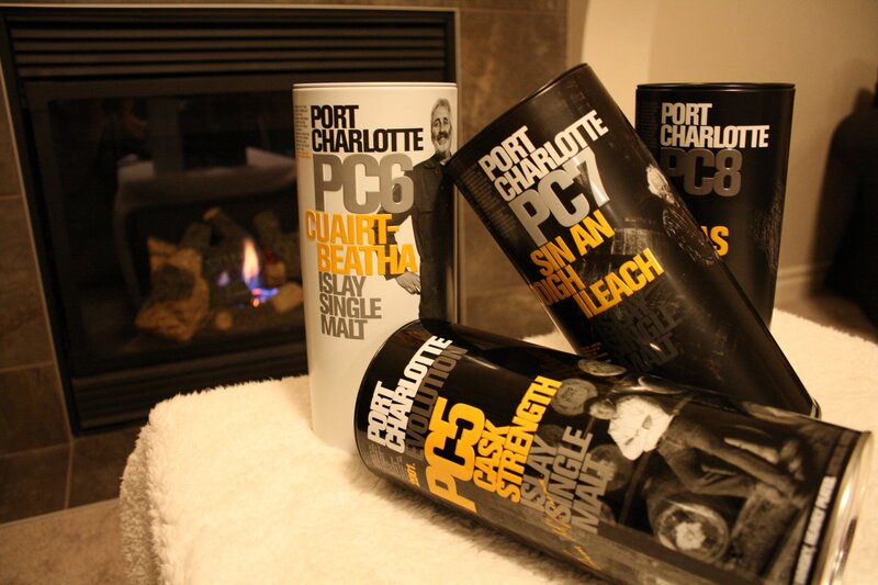 Port Charlotte whisky cans by fireplace