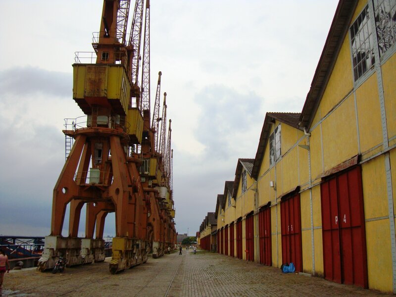 Port with cranes and yellow buildings