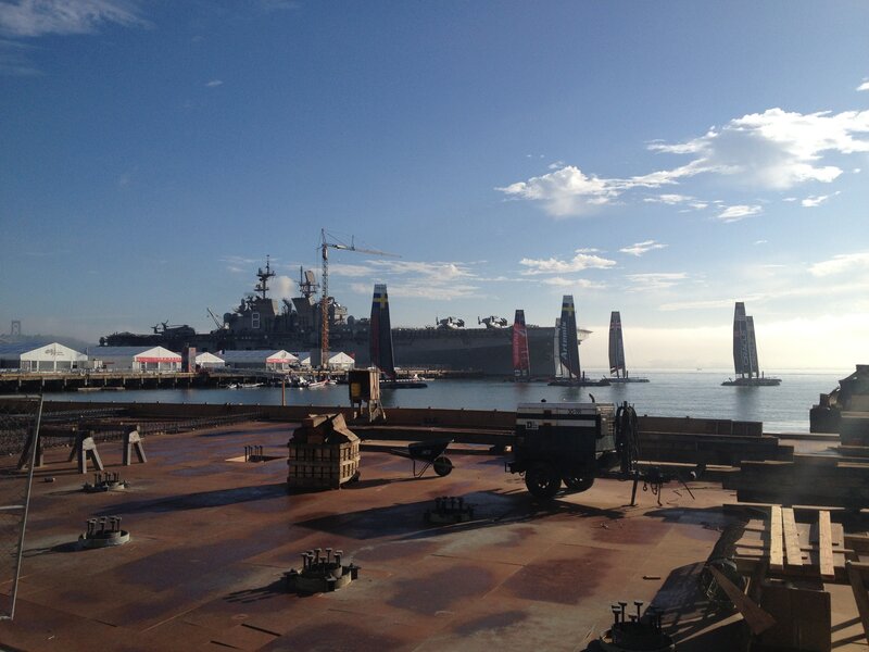 Port with naval ship and sailboats
