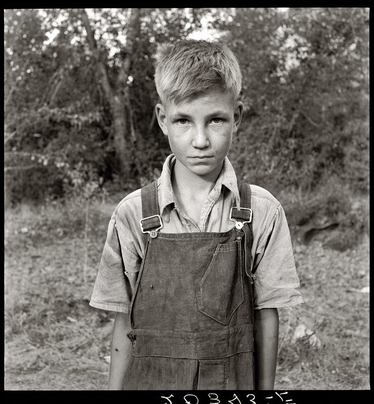 Portrait of a young boy in overalls
