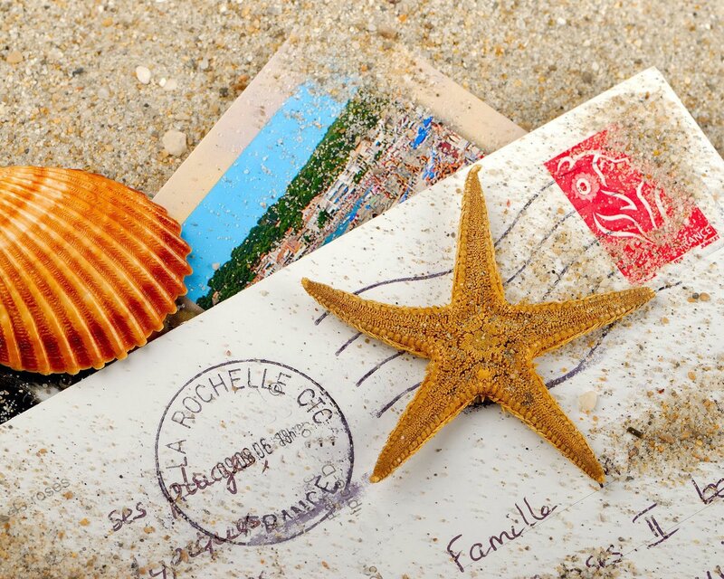 Postcard and starfish on beach
