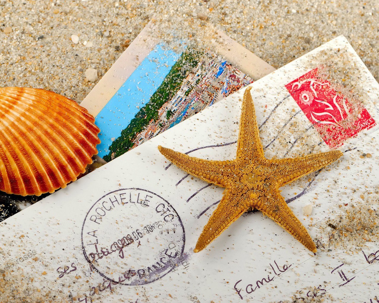 Postcard and starfish on beach