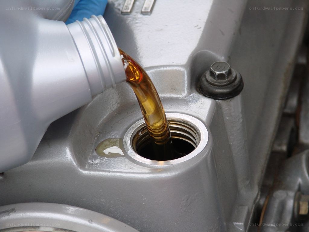 Pouring engine oil into a car