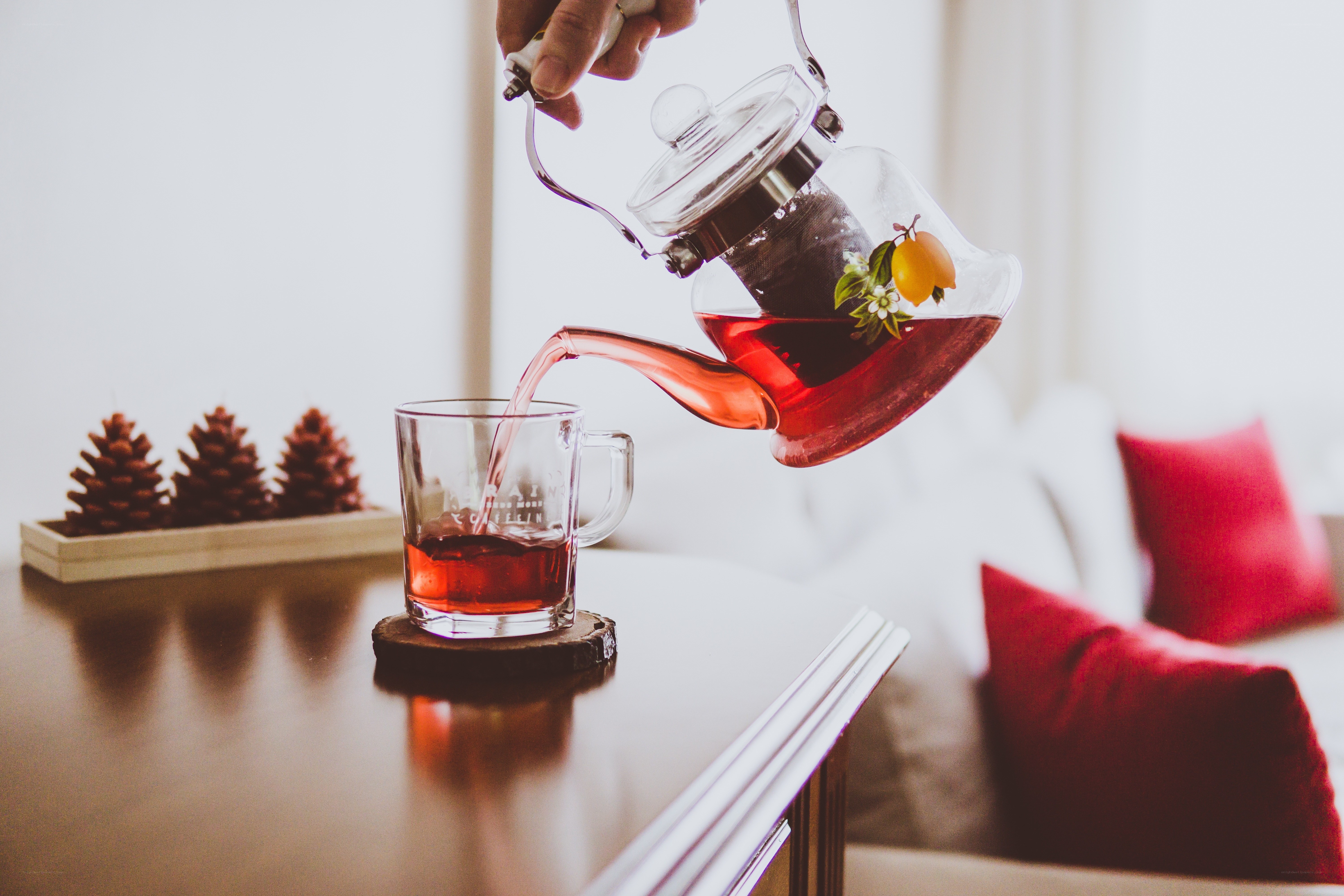 Pouring tea from a glass teapot