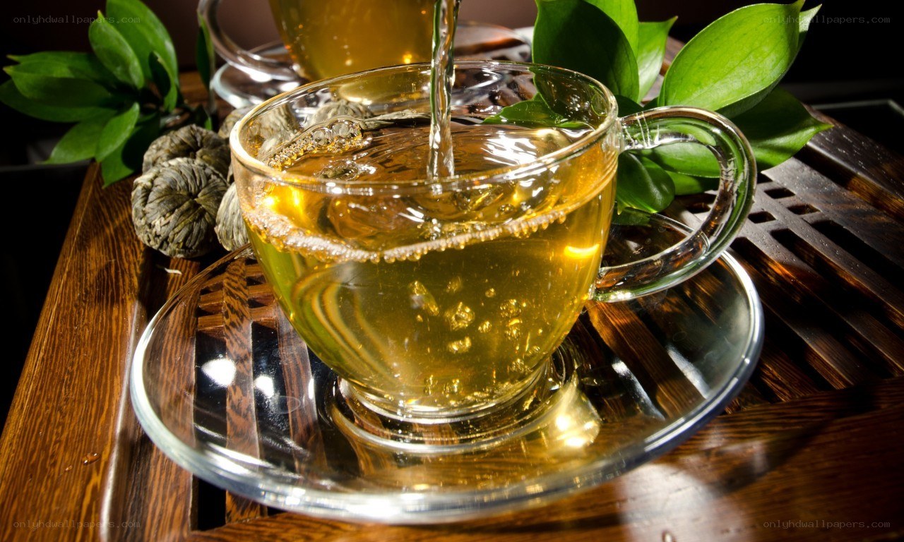 Pouring tea into a glass cup