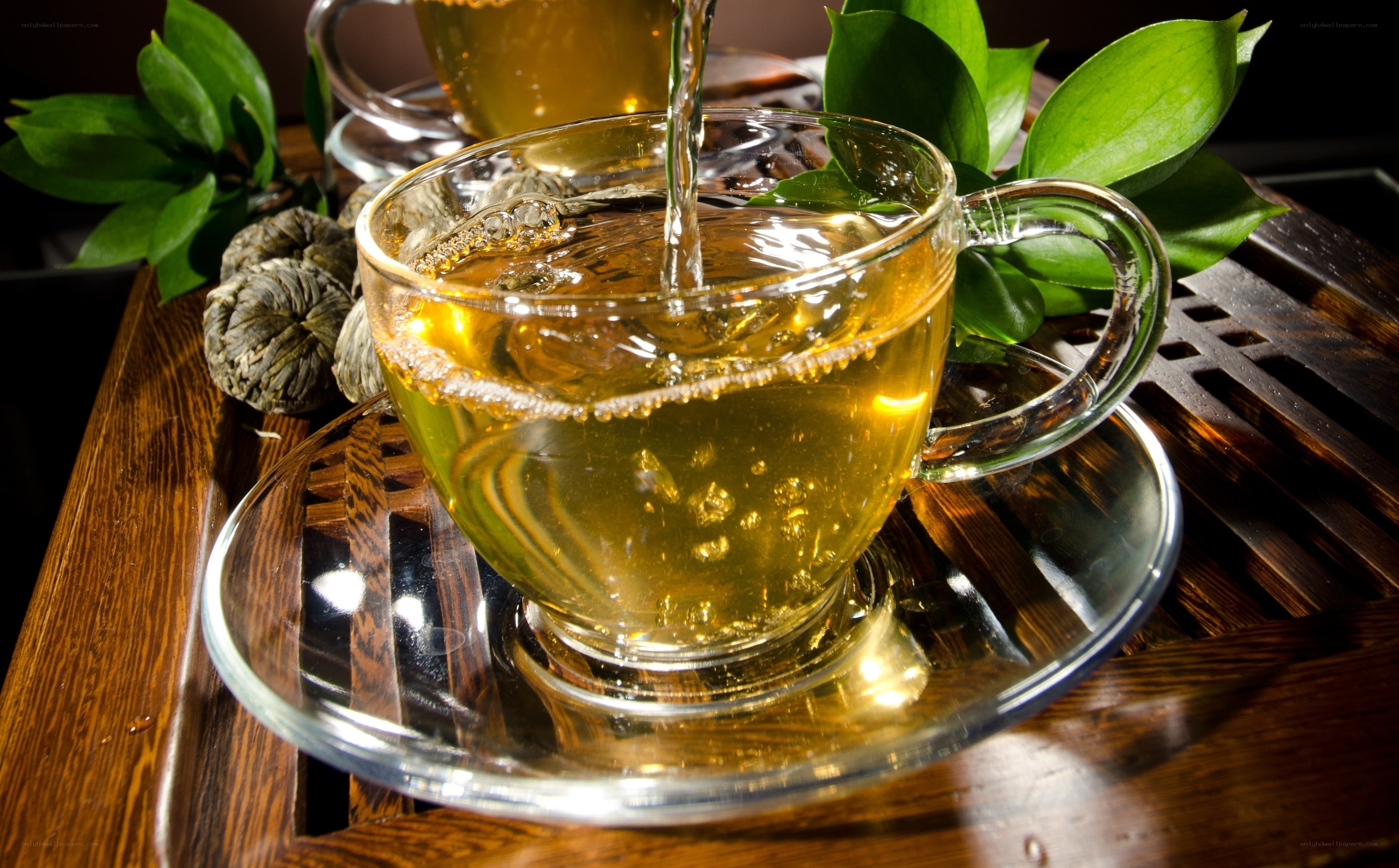 Pouring tea into a glass cup