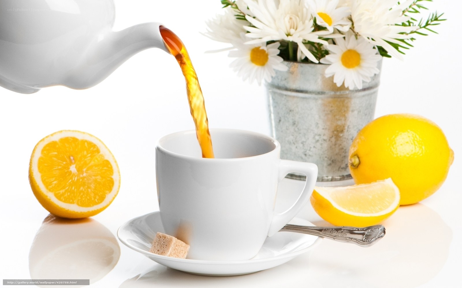 Pouring tea with lemons and flowers