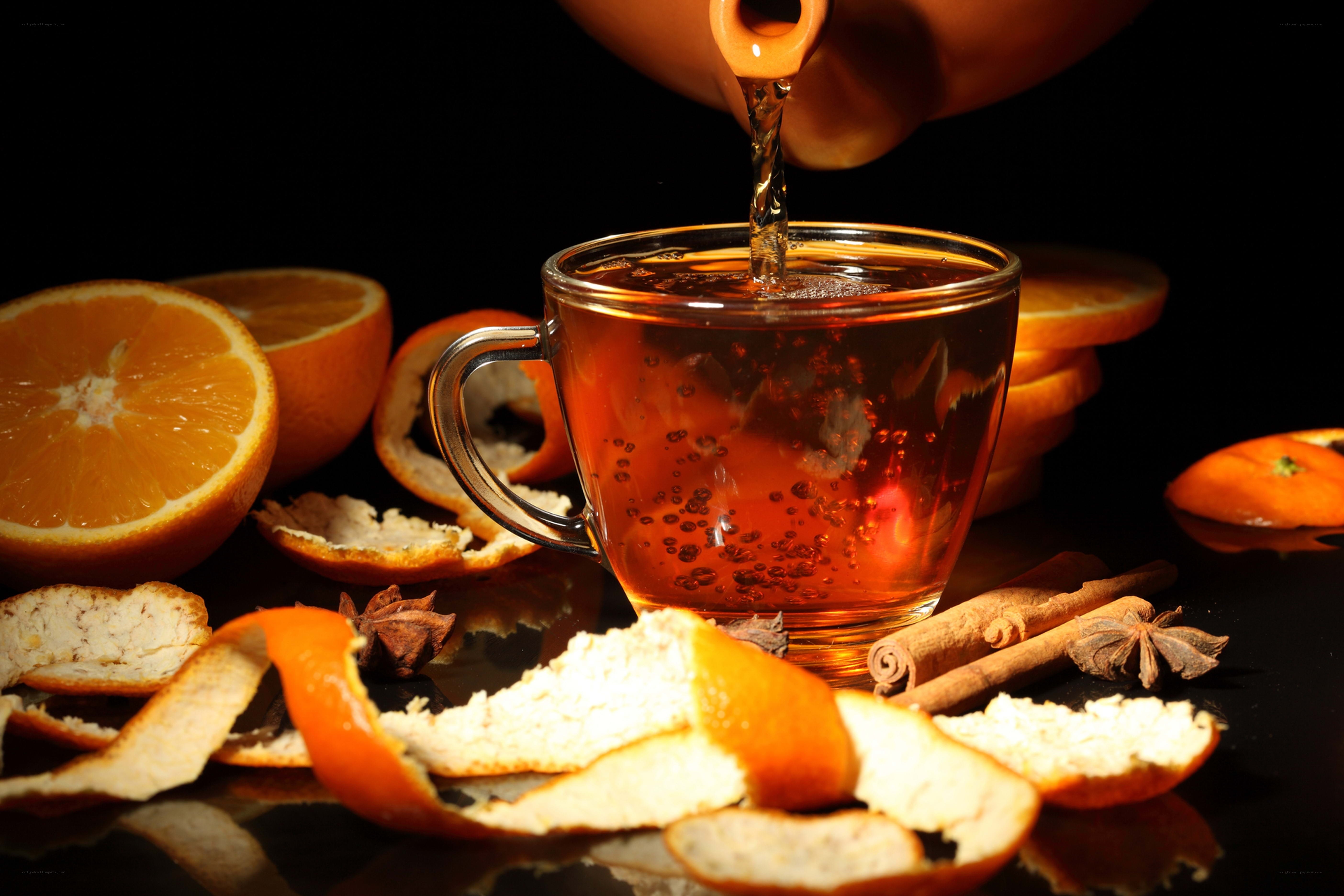 Pouring tea with orange and spices