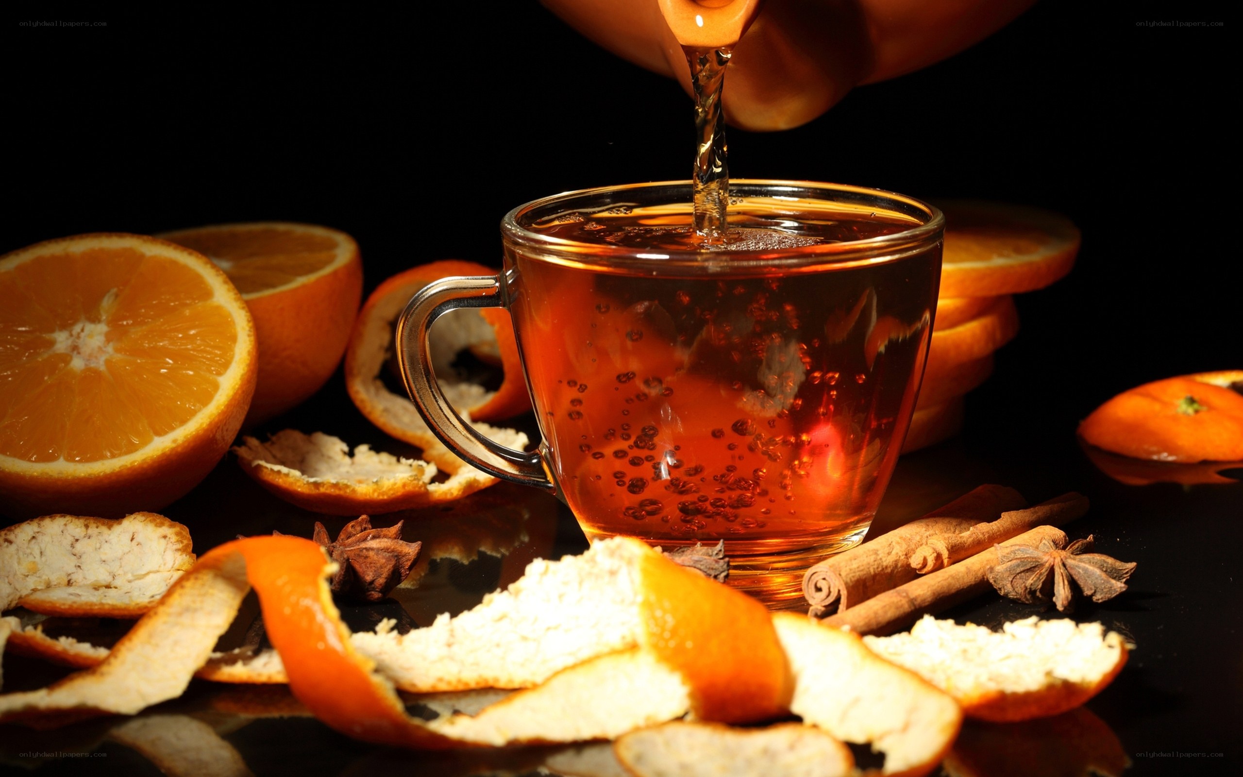 Pouring tea with oranges and spices