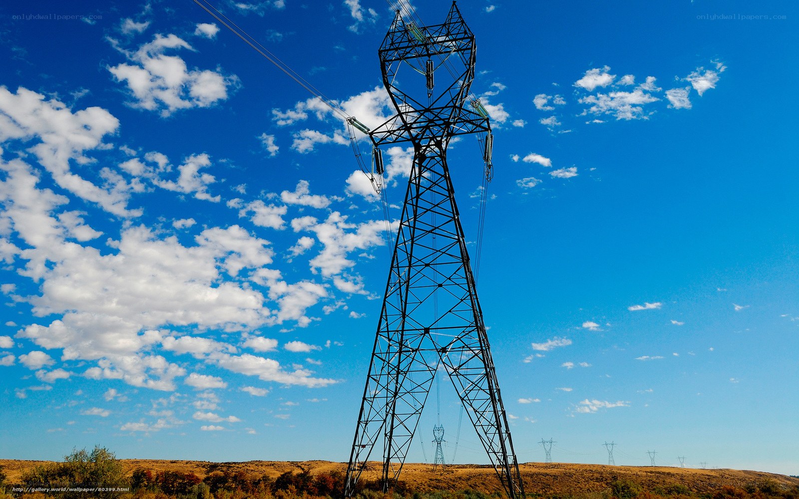 Power line tower against blue sky