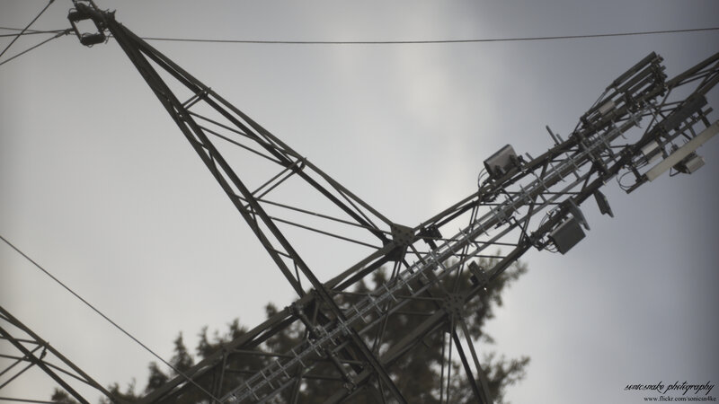 Power line tower against sky