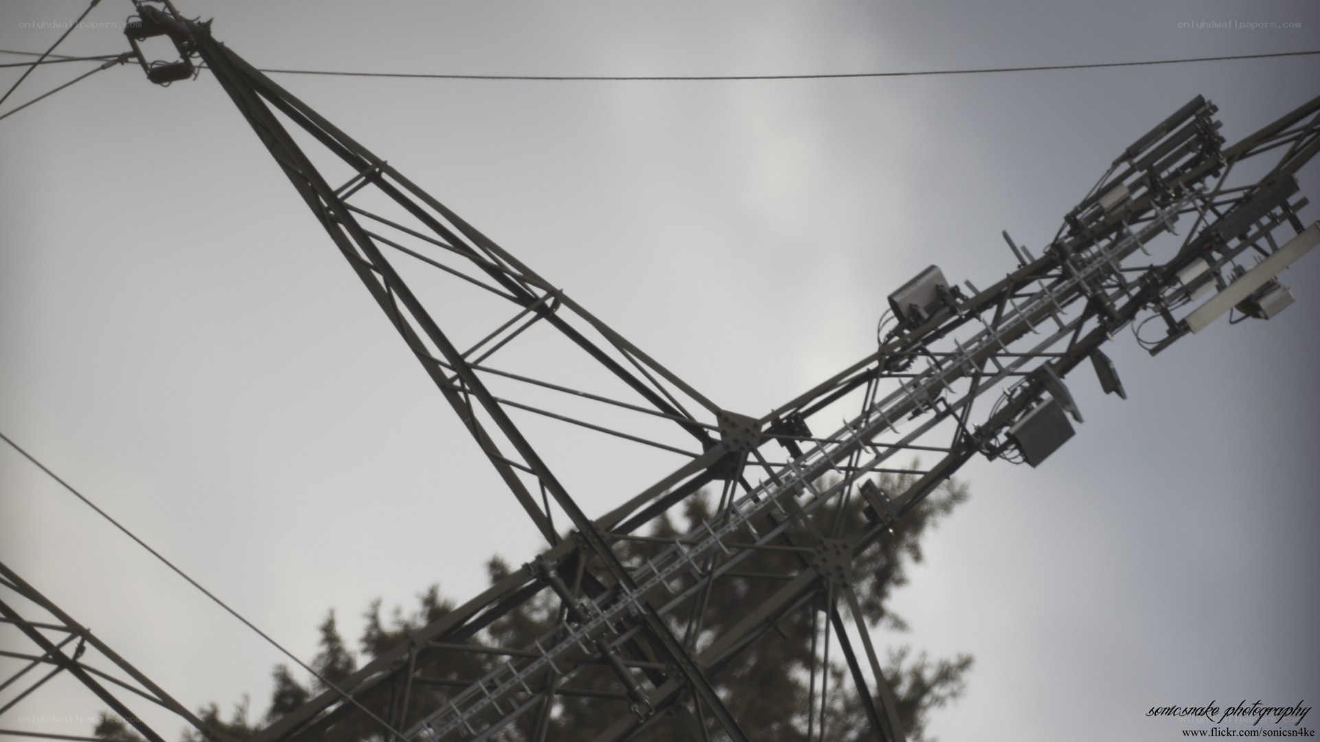 Power line tower against sky