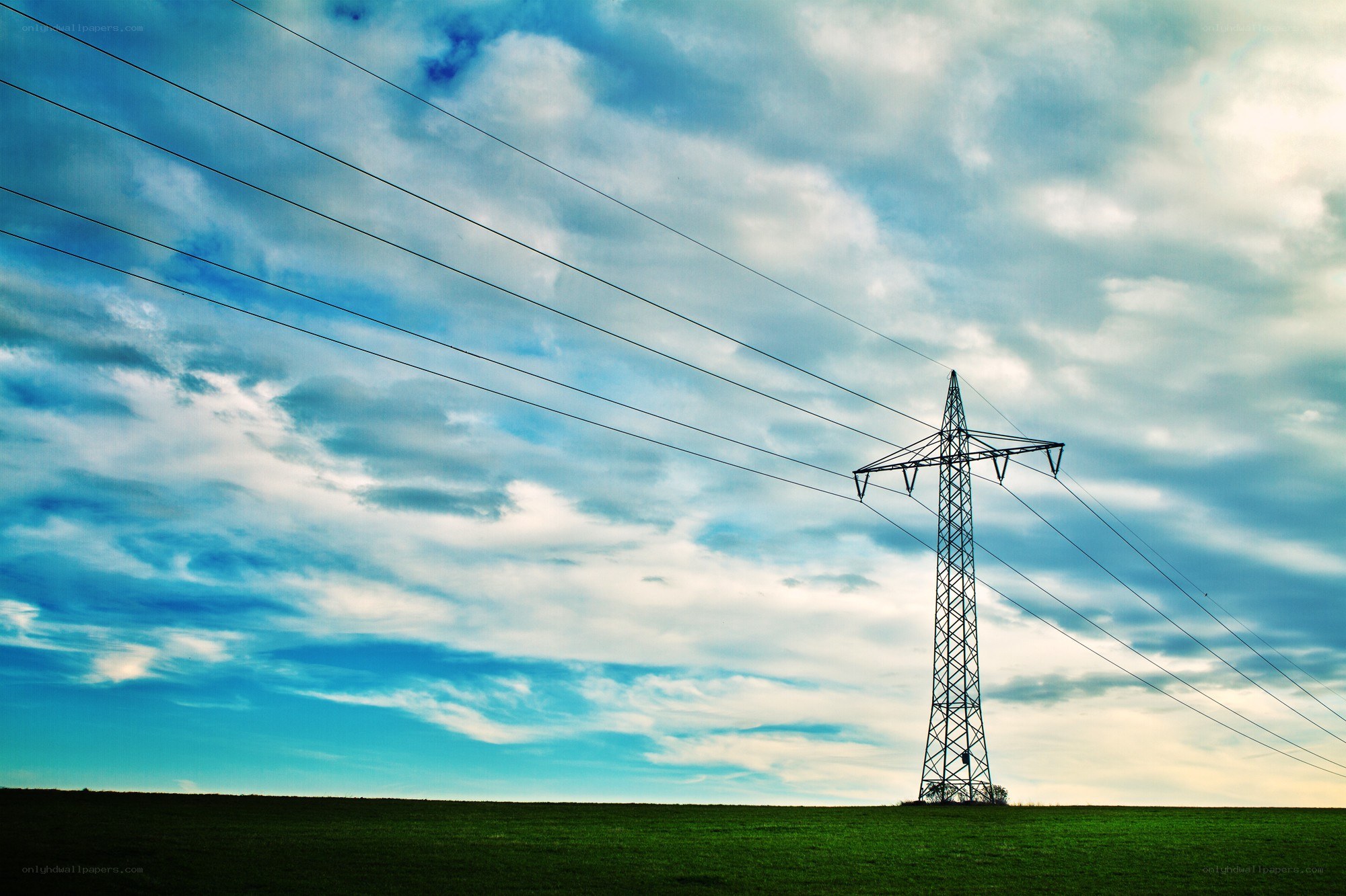 Power line tower in a field