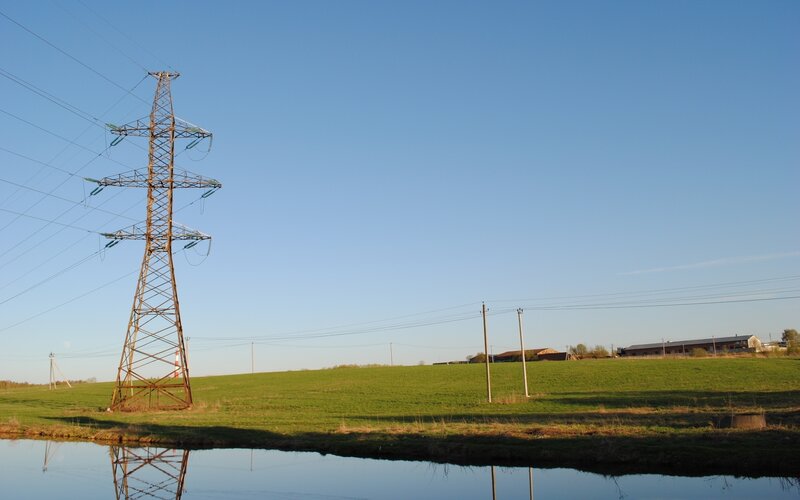 Power line tower in a field