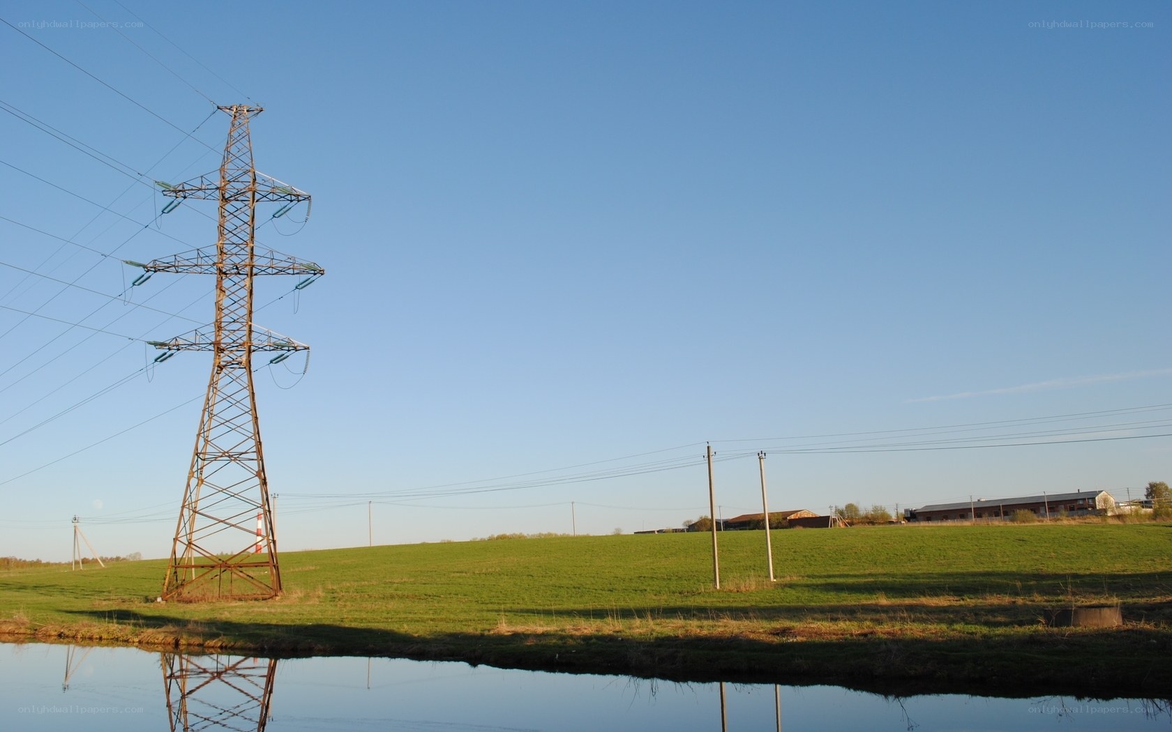 Power line tower in a field