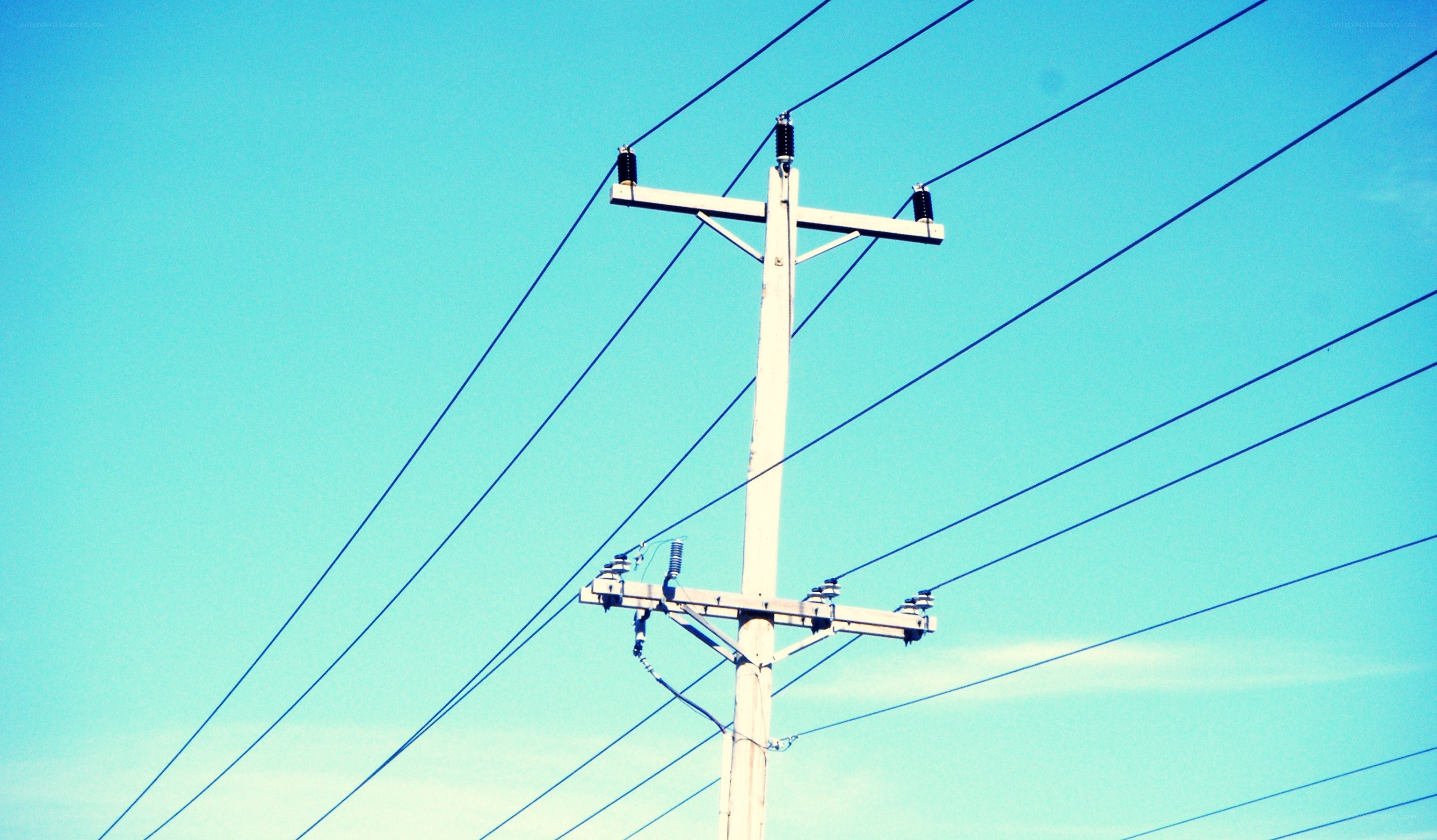 Power lines against blue sky