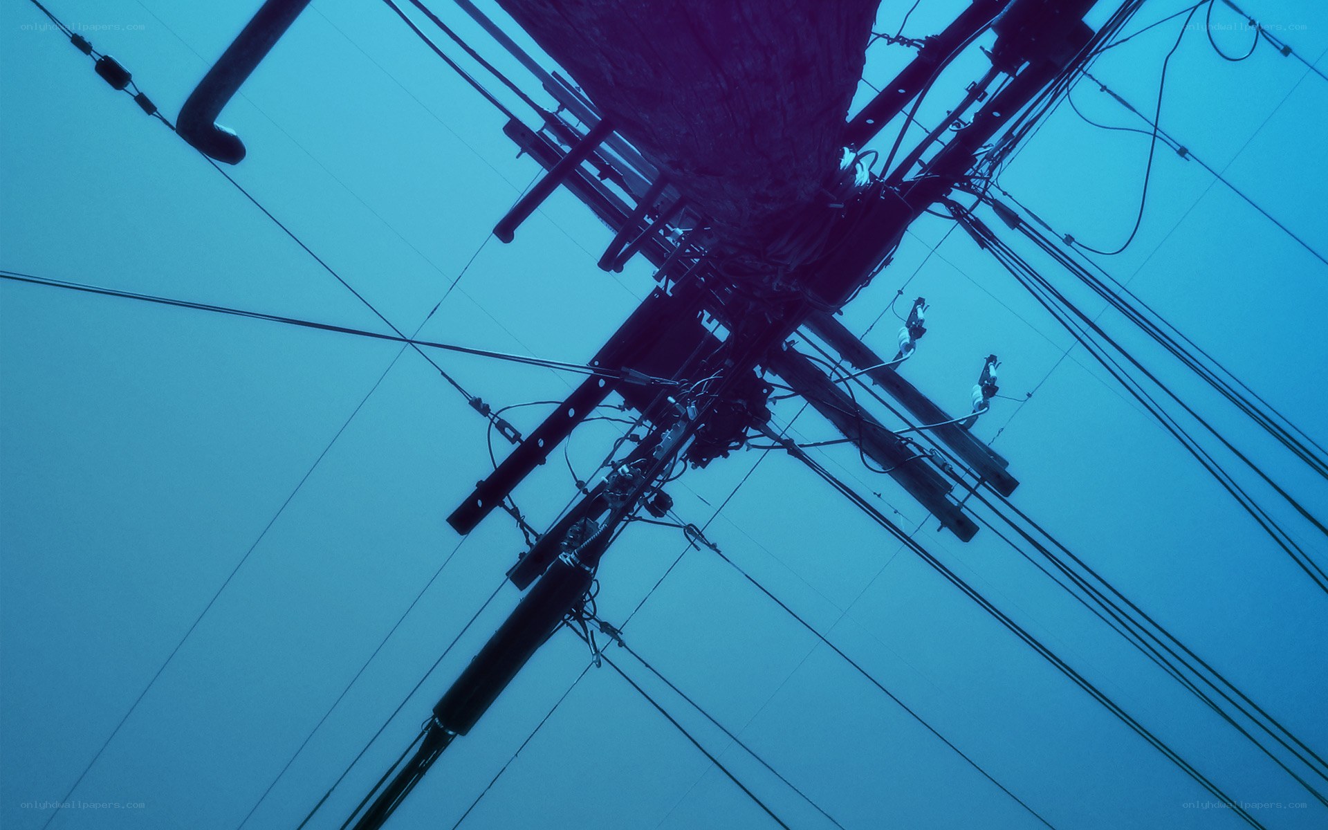 Power lines against blue sky