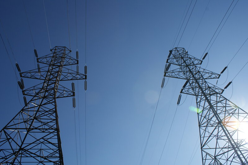 Power lines against blue sky