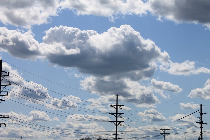 Power lines under cloudy sky