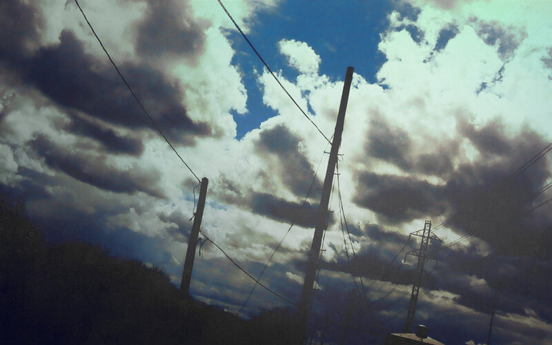 Power lines under cloudy sky