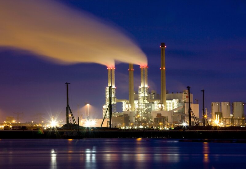Power plant at night with smoke