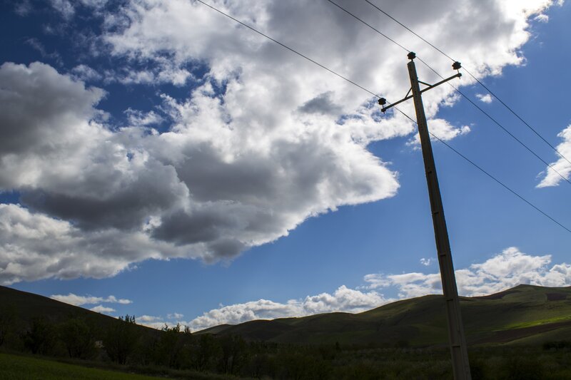 Power pole under cloudy sky