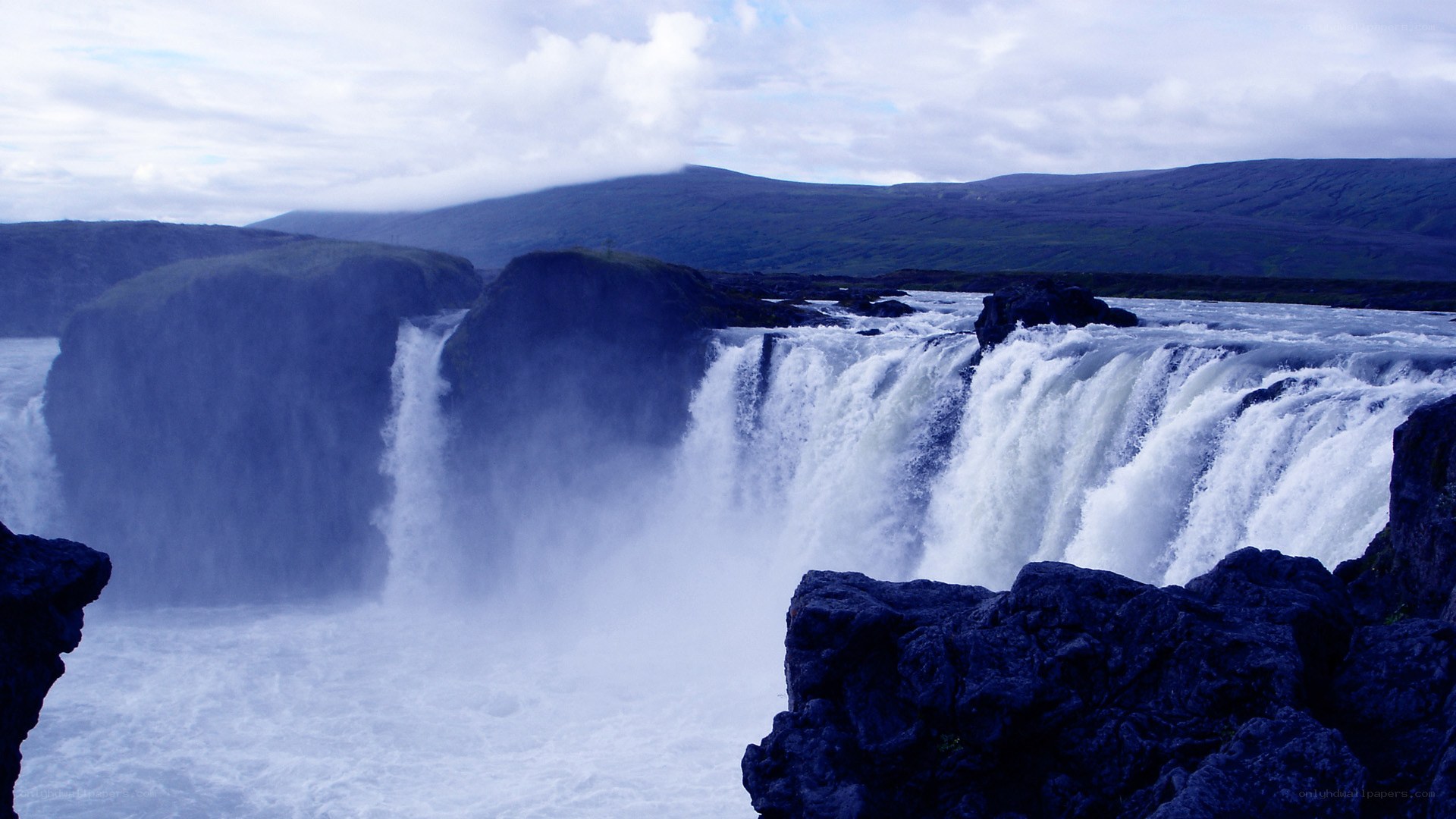 powerful waterfall in a rugged landscape