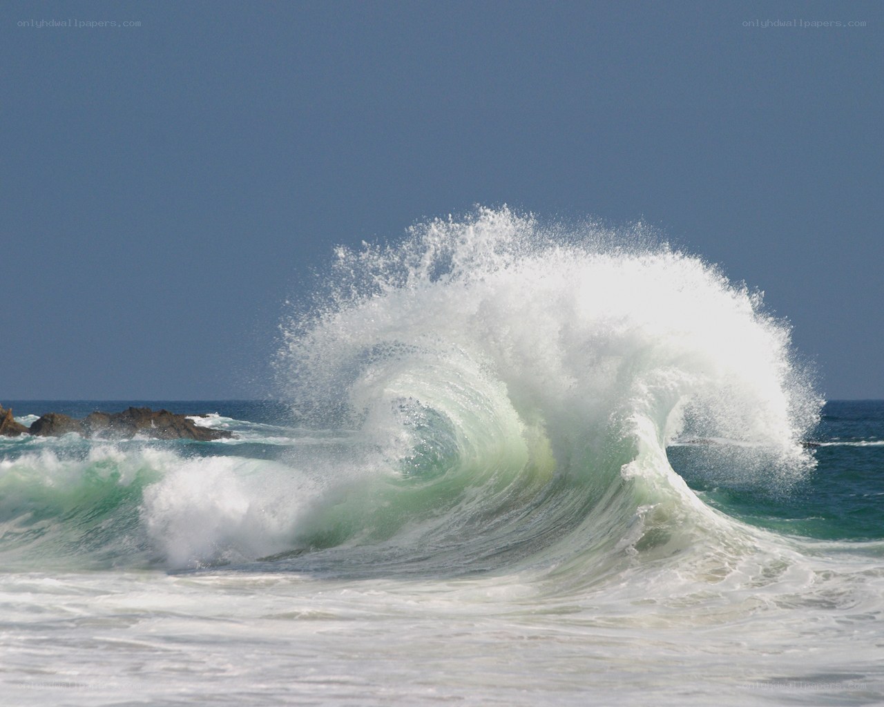 Powerful wave crashing on rocks