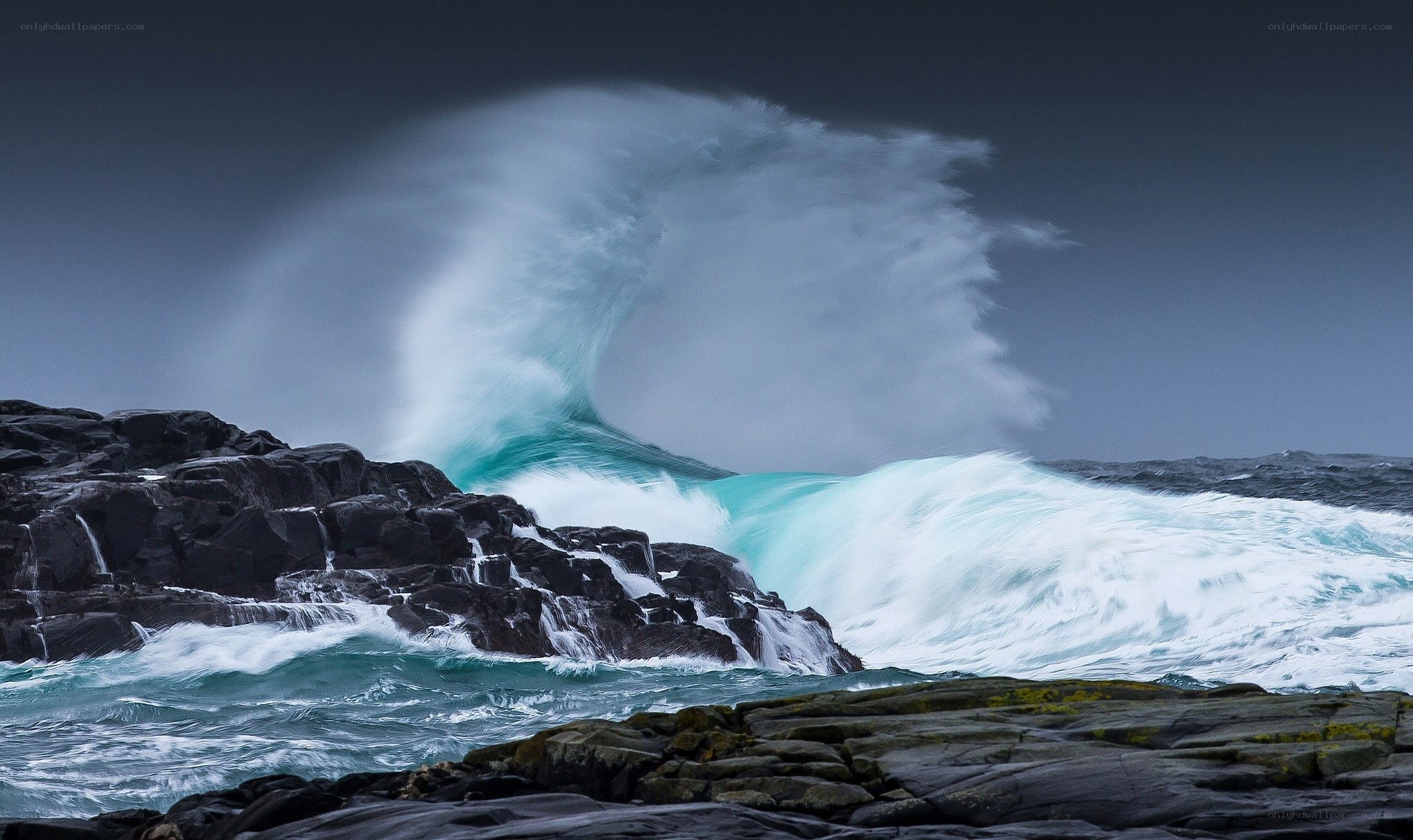 Powerful wave crashing on rocks