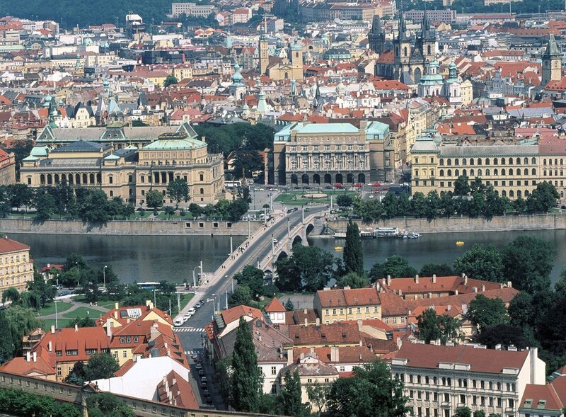 Prague Cityscape — Red, Serene, Afternoon, Photograph, River, Bridge, Buildings