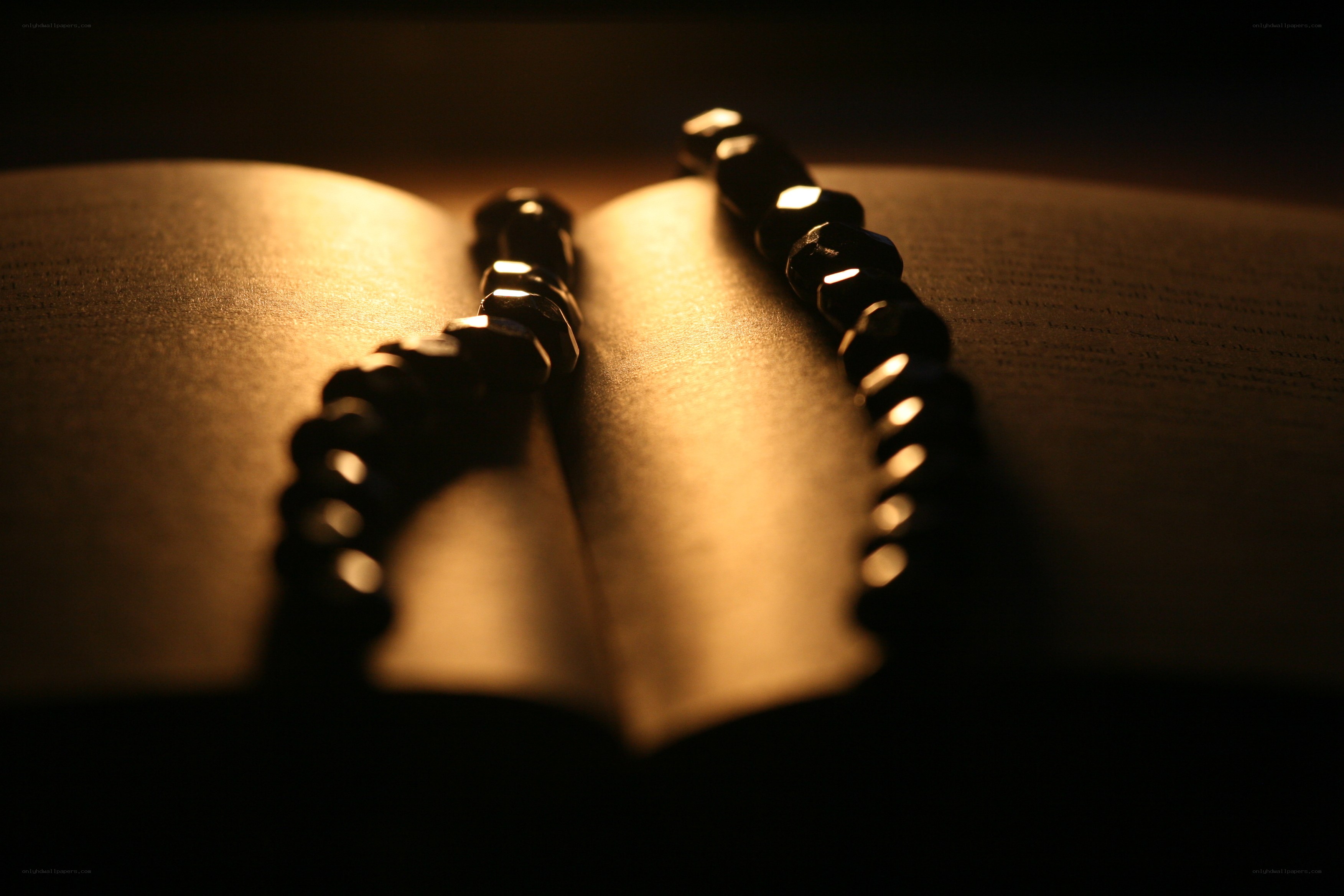 prayer beads on open book