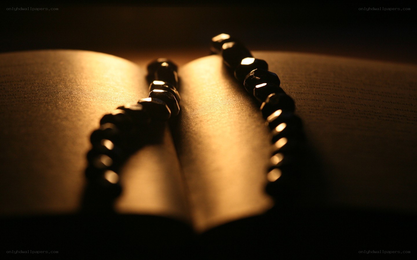 prayer beads on open book