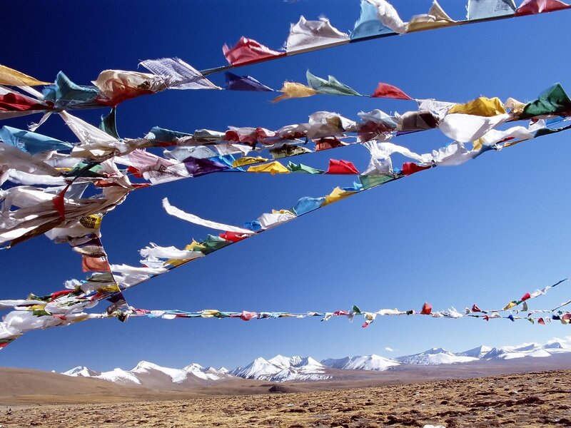 Prayer flags over snowy mountains