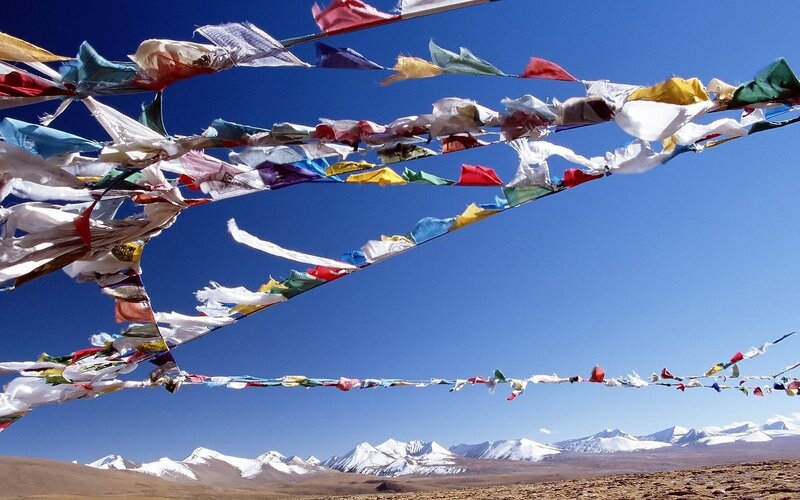 Prayer flags over snowy mountains