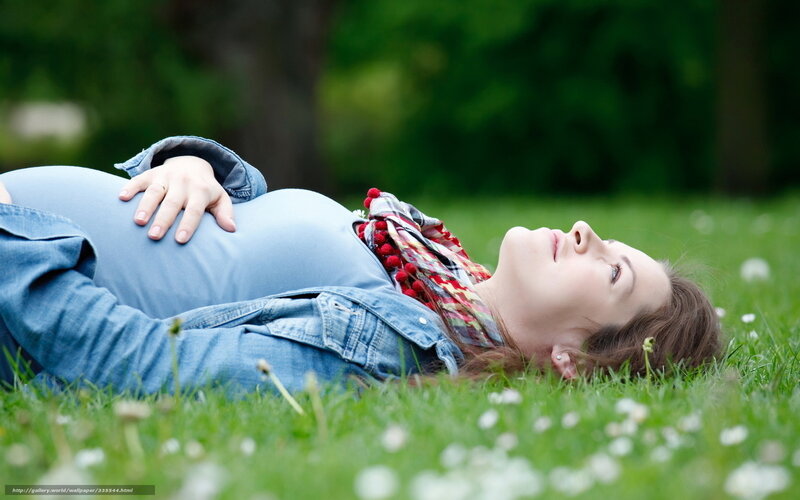 Pregnant Woman Lying on Grass — Green