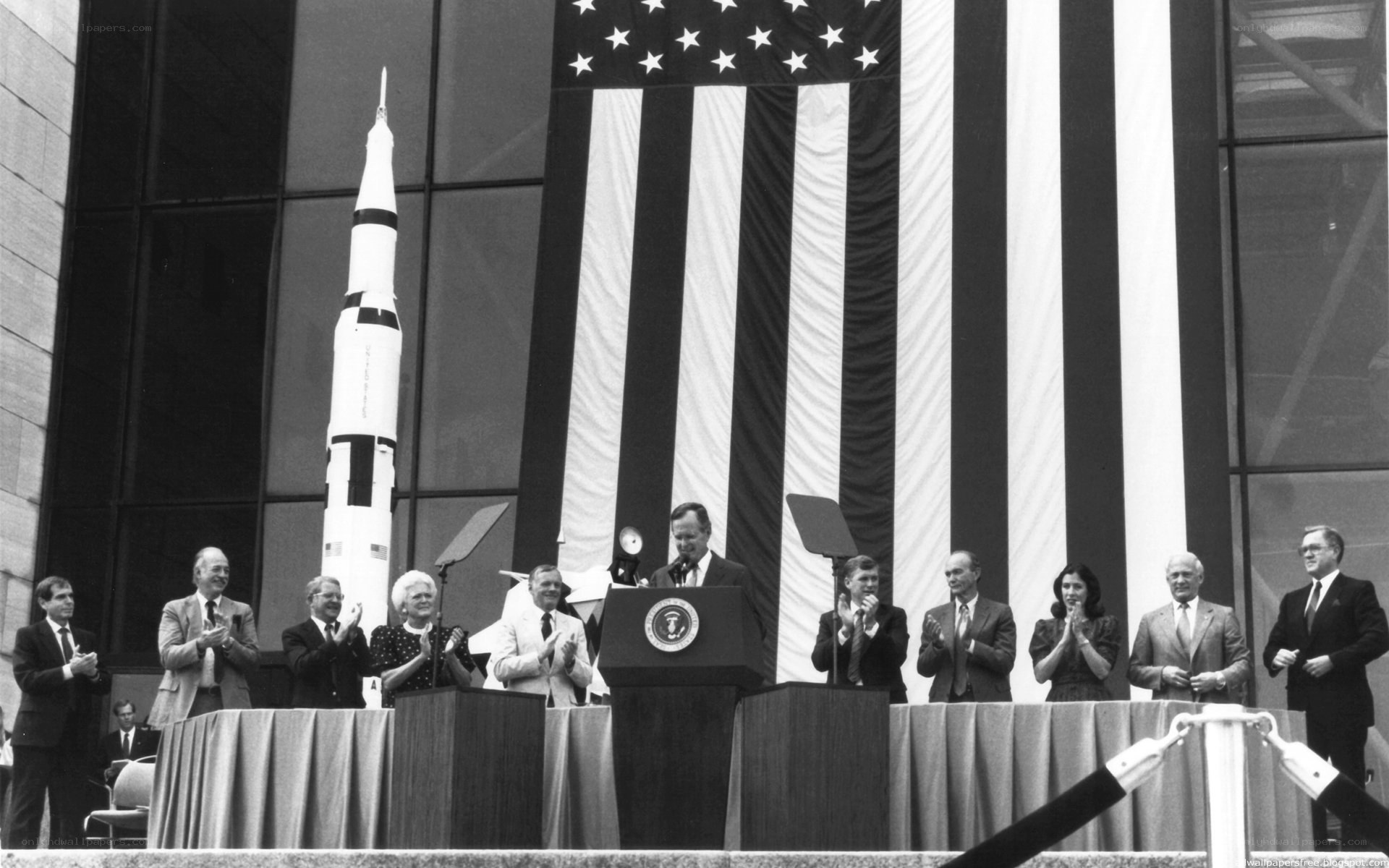 President at podium with rocket