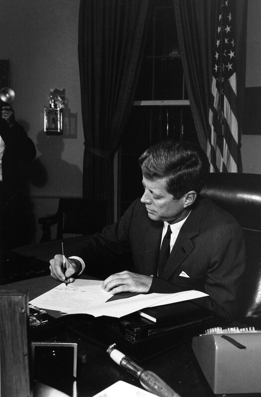 President signing document