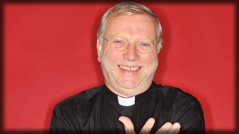 Priest smiling at camera