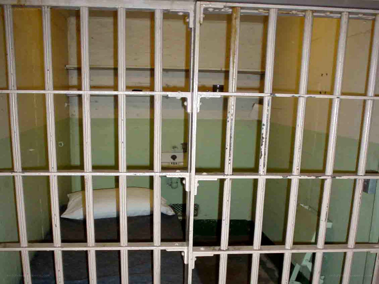 prison cell with bed and bars