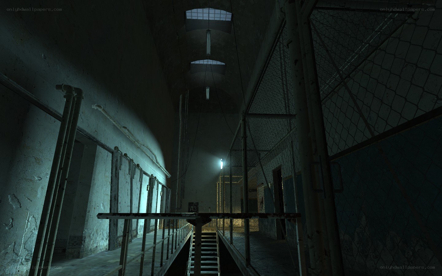 prison corridor with chain-link fence