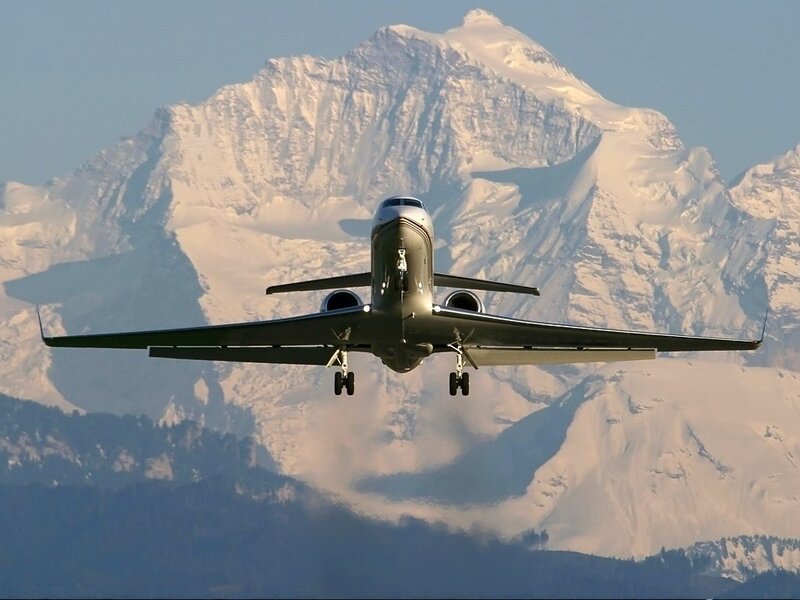 private jet approaching mountain
