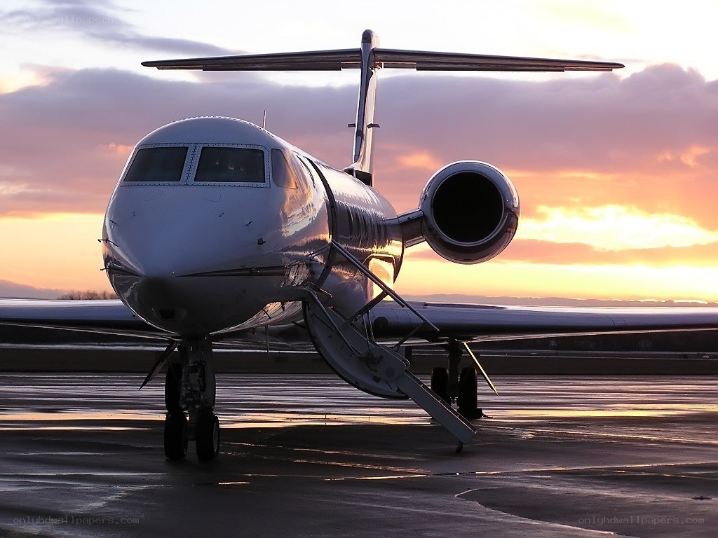 private jet at sunset