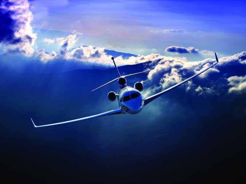 Private jet flying above clouds