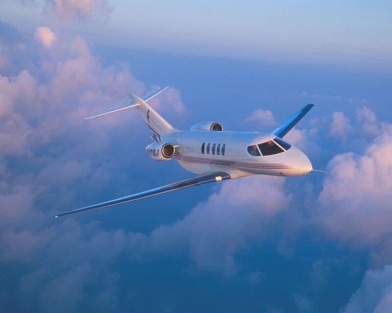 private jet flying above clouds