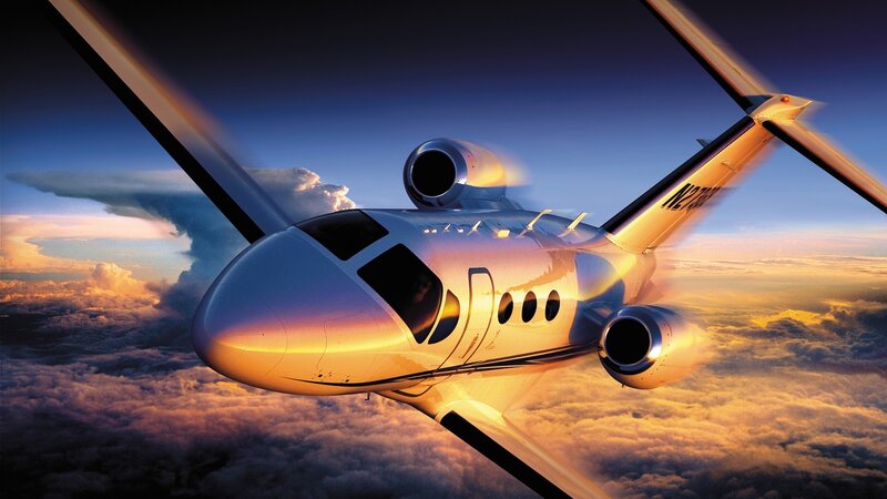 private jet flying above clouds