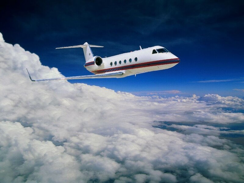 private jet flying above clouds