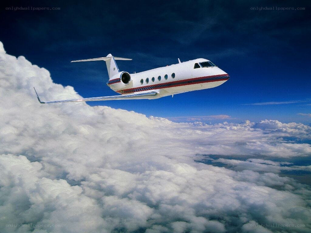 private jet flying above clouds