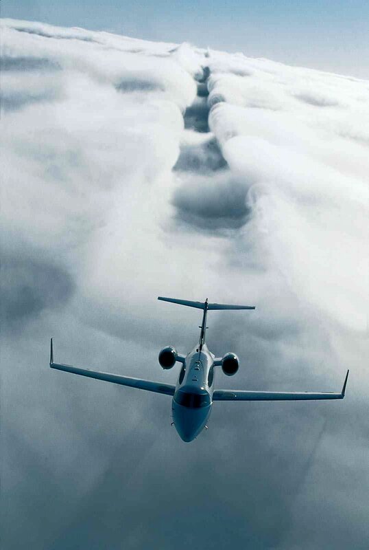 Private Jet Flying Above Clouds — Blue